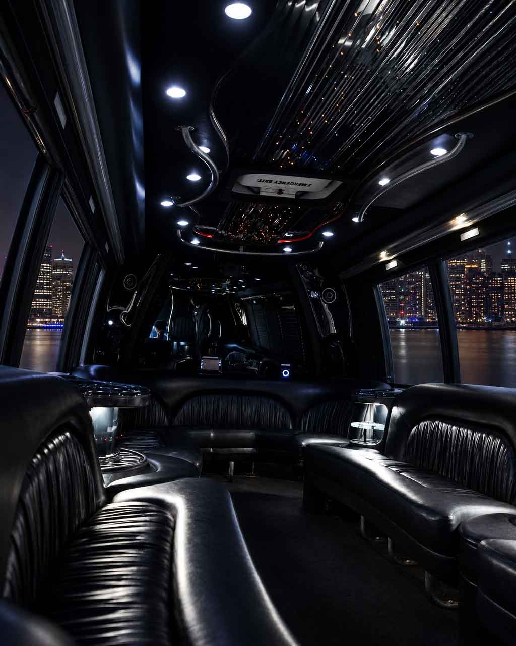 Luxury party bus interior with black leather seating and ambient lighting in Vancouver